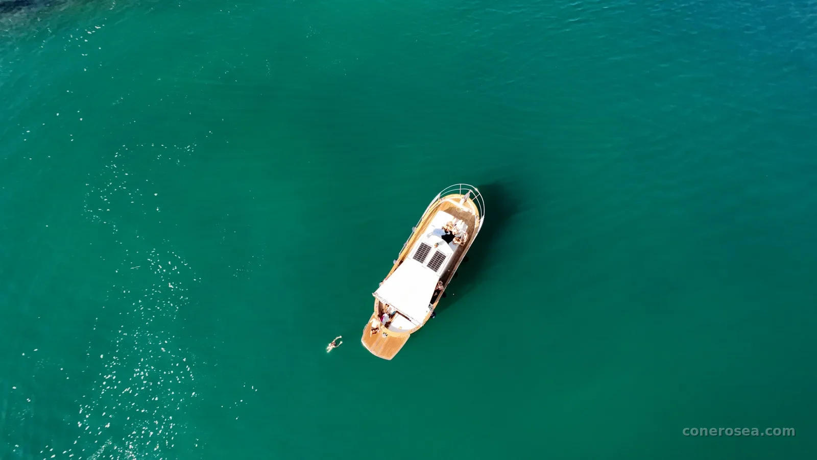 Veduta dall'alto della barca sulle acque verde smeraldo del Conero